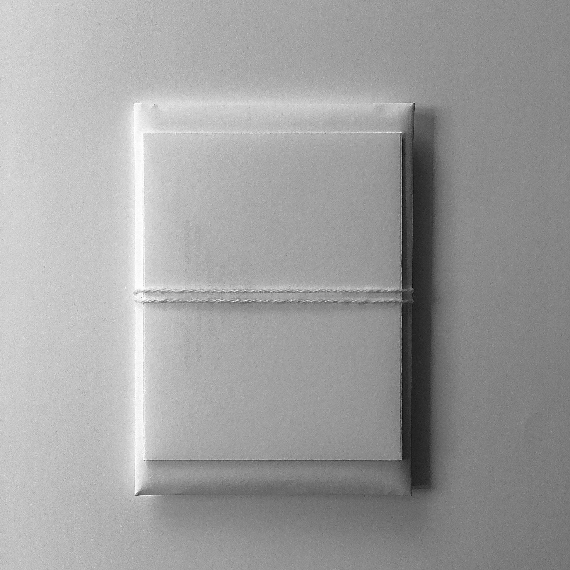 white/cream colour gift pouch tied with white/cream colour wool