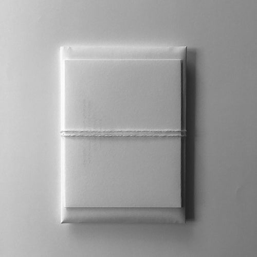 white/cream colour gift pouch tied with white/cream colour wool